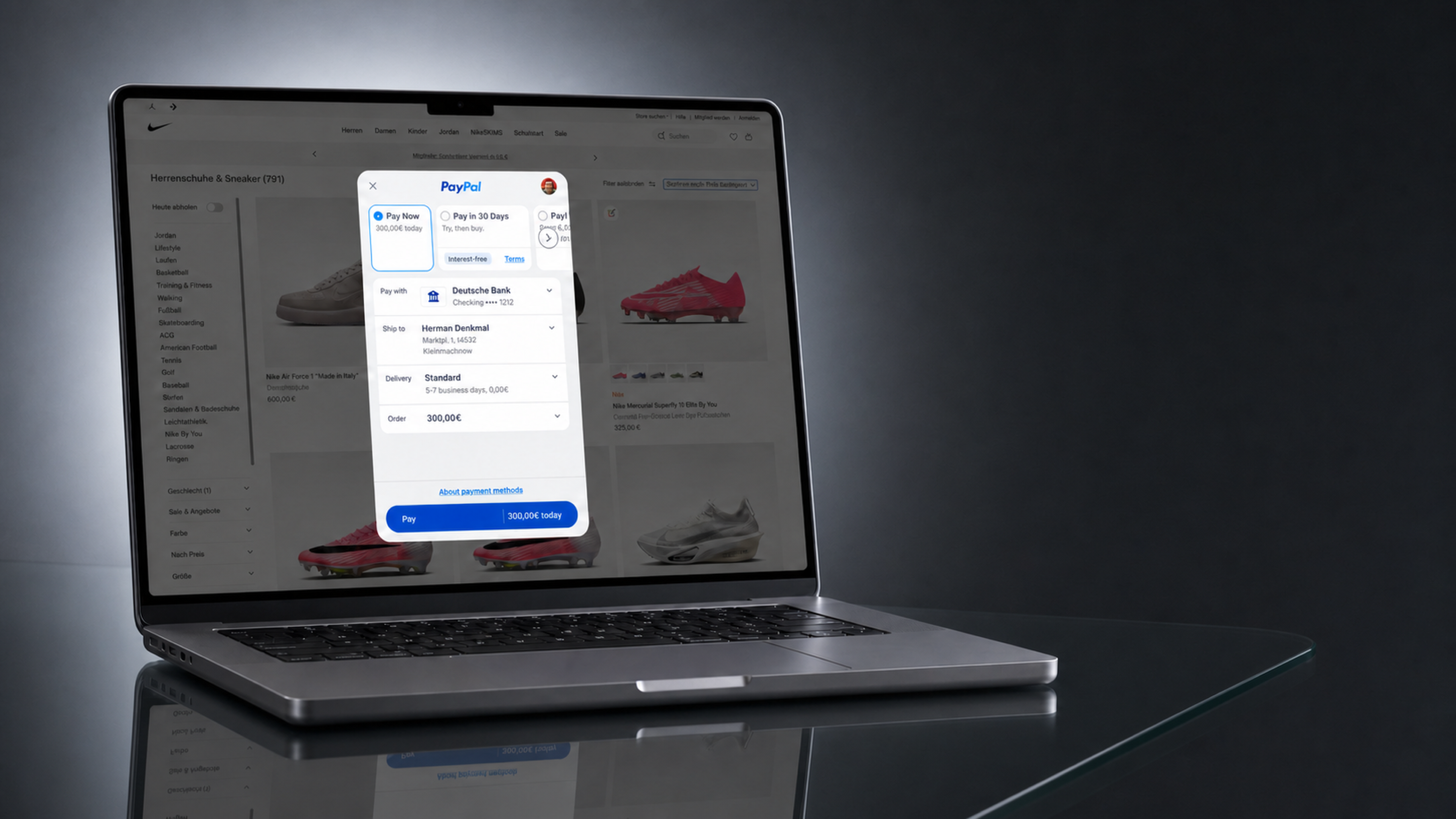 A MacBook on a glass table with the PayPal checkout open over a German storefront: Pay Now, Pay in 30 Days, and Ratenzahlung offered side by side.